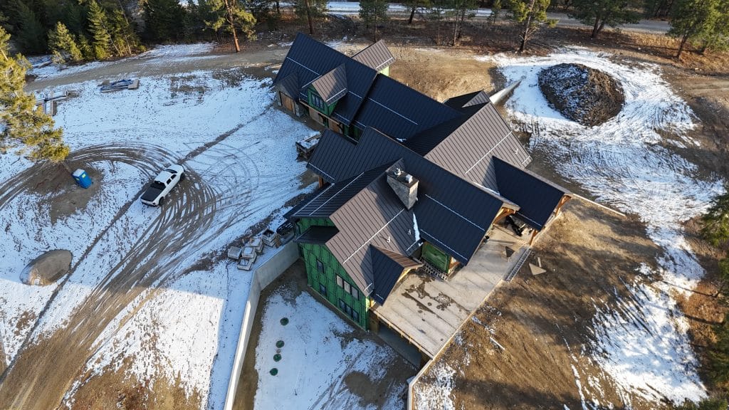 Aerial view of a new home with standing seam roofing